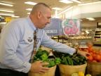 Food Lion store manager restocks local produce inside Timberville, Va., store (Photo: Business Wire)